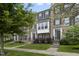 Charming townhome with brick facade, complemented by lush greenery and manicured lawns at 258 Coatsville Dr, Westfield, IN 46074