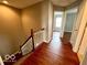Upstairs hallway with wooden railing and hardwood floors at 258 Coatsville Dr, Westfield, IN 46074