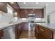 Modern kitchen with stainless steel appliances, dark wood cabinetry, and sleek countertops at 258 Coatsville Dr, Westfield, IN 46074