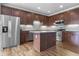 Bright kitchen with stainless steel appliances, center island, and ample cabinet space at 258 Coatsville Dr, Westfield, IN 46074