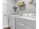 Functional laundry room featuring modern Whirlpool washer and dryer with storage shelf above at 258 Coatsville Dr, Westfield, IN 46074