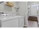 Functional laundry room featuring modern Whirlpool washer and dryer near staircase at 258 Coatsville Dr, Westfield, IN 46074