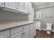 Practical laundry room with ample storage, including upper and lower cabinets, plus a convenient half-bath at 258 Coatsville Dr, Westfield, IN 46074