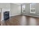 Bright living room featuring hardwood floors, a fireplace, and large windows for natural light at 258 Coatsville Dr, Westfield, IN 46074