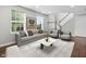 Living room with natural light from windows, showing furniture and staircase at 258 Coatsville Dr, Westfield, IN 46074