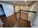 A well-lit staircase featuring dark wood steps and a white railing at 258 Coatsville Dr, Westfield, IN 46074