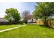 Spacious green backyard with a concrete pathway leading to the home at 270 W Broadway St, Greenwood, IN 46142