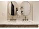 Bright bathroom offers a double vanity, stylish mirrors, and great counterspace and a warm modern aesthetic at 270 W Broadway St, Greenwood, IN 46142