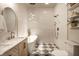 Well-lit bathroom features a soaking tub, modern vanity, and checkered floors for a stylish aesthetic at 270 W Broadway St, Greenwood, IN 46142