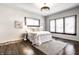 Bright bedroom with large windows, hardwood floors, stylish chandelier, and neutral color palette with decorative rug at 270 W Broadway St, Greenwood, IN 46142