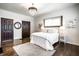 Light-filled bedroom with decorative rug, chandelier, hardwood floors, and accent lighting near the bed at 270 W Broadway St, Greenwood, IN 46142
