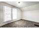 Clean and bright bedroom with neutral carpet, white walls, and natural light, providing a serene retreat at 270 W Broadway St, Greenwood, IN 46142