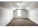 Spacious bedroom with neutral carpet, bright window, and minimalist design, offering a blank canvas at 270 W Broadway St, Greenwood, IN 46142
