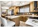 Bright kitchen with marble floors, island seating, and stainless steel refrigerator overlooking a cozy living space at 270 W Broadway St, Greenwood, IN 46142