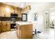 Elegant kitchen features wooden cabinets, stainless appliances, an island eating area and modern decorative fixtures at 270 W Broadway St, Greenwood, IN 46142