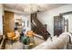 Stunning living room featuring a staircase and a view into the kitchen at 270 W Broadway St, Greenwood, IN 46142