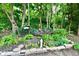 View of a backyard with landscaping, decorative accents, and mature trees at 2805 Rylee Ct, Greenwood, IN 46143