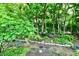 Scenic backyard with lush greenery and landscaping featuring decorative statuary at 2805 Rylee Ct, Greenwood, IN 46143