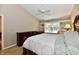 Bedroom with vaulted ceiling, white ceiling fan, large window with build in seating and shelves and soft neutral color palette at 2805 Rylee Ct, Greenwood, IN 46143