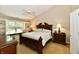 Bedroom with vaulted ceiling and large window with build in seating. The room features a ceiling fan and detailed wood furniture at 2805 Rylee Ct, Greenwood, IN 46143