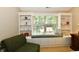 Bedroom features built in bookshelves on either side of a window with seating, perfect for enjoying sunlight and a good book at 2805 Rylee Ct, Greenwood, IN 46143