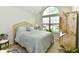 Comfortable bedroom with large, arched window, sloped ceiling, and beautiful wood furniture and a neutral colored bedspread at 2805 Rylee Ct, Greenwood, IN 46143