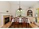 Dining room with a fireplace, chandelier, and a white china cabinet with a variety of dishes at 2805 Rylee Ct, Greenwood, IN 46143