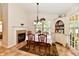 Formal dining room with fireplace, decorative chandelier, and china cabinet at 2805 Rylee Ct, Greenwood, IN 46143