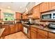 Well-equipped kitchen featuring modern appliances, wood cabinets, and a tile backsplash at 2805 Rylee Ct, Greenwood, IN 46143