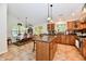 Spacious kitchen with wooden cabinets, center island, tile floors, and adjacent dining area, perfect for Gathering meals at 2805 Rylee Ct, Greenwood, IN 46143