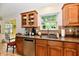 Bright kitchen with stainless steel dishwasher, wooden cabinets, and adjacent breakfast nook at 2805 Rylee Ct, Greenwood, IN 46143