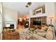 Comfortable living room featuring a fireplace, built-in entertainment center, and open access to the kitchen at 2805 Rylee Ct, Greenwood, IN 46143