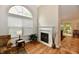Cozy living room with a fireplace, large window, and chair with wood floors at 2805 Rylee Ct, Greenwood, IN 46143