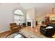 Bright living room with a fireplace, large window, and hardwood floors offers a cozy seating area at 2805 Rylee Ct, Greenwood, IN 46143
