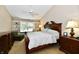 Comfortable bedroom featuring a large bed with a decorative wood frame and a cozy window seat at 2805 Rylee Ct, Greenwood, IN 46143
