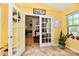 Sunlit room with French doors that open to a formal dining room, creating a seamless transition between spaces at 2805 Rylee Ct, Greenwood, IN 46143