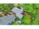Aerial view showcases a backyard with lush grass, a patio set, and a detached garage at 2832 Hillside Ave, Indianapolis, IN 46218