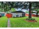 Exterior view of the home with a vibrant front lawn and attractive landscaping at 2832 Hillside Ave, Indianapolis, IN 46218