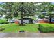 Exterior view of the home featuring a lush front lawn and mature landscaping adding to the curb appeal at 2832 Hillside Ave, Indianapolis, IN 46218