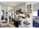 Kitchen displaying stainless steel appliances, grey cabinets, and a view to a living space at 2832 Hillside Ave, Indianapolis, IN 46218