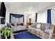Living room showcasing plush sofas, blue accents, and a large window with natural light at 2832 Hillside Ave, Indianapolis, IN 46218