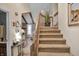 View of the entryway with staircase with wood accents and neutral decor at 2925 Horse Hill East Dr, Indianapolis, IN 46214