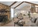 Cozy living room features stone fireplace, exposed beams and natural lighting at 2925 Horse Hill East Dr, Indianapolis, IN 46214