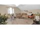 Bright living room with a large sectional sofa, decorative plants, and natural light from the window at 2925 Horse Hill East Dr, Indianapolis, IN 46214