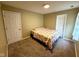 Carpeted bedroom with closet, bed, and bright natural light coming in from the window at 3065 Hemlock Way, Indianapolis, IN 46203