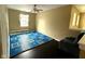 Bright bedroom with dark wood floors, a window, and chair by the stairwell at 3065 Hemlock Way, Indianapolis, IN 46203