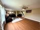 Open-concept living room with hardwood floors, sofas, and staircase to the second floor at 3065 Hemlock Way, Indianapolis, IN 46203