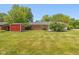 Expansive backyard with lawn, storage shed, and mature trees at 311 Thornberry Dr, Carmel, IN 46032
