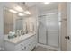 Well-lit bathroom featuring a large mirror and glass-enclosed shower at 311 Thornberry Dr, Carmel, IN 46032