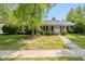 Charming brick home with manicured lawn and mature tree, creating a welcoming curb appeal at 311 Thornberry Dr, Carmel, IN 46032